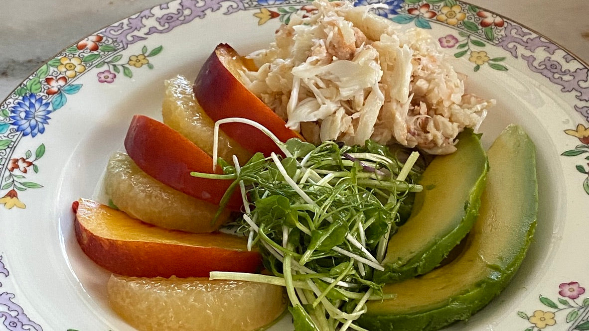 plate with crab meat grapefruit nectarine avocado and microgreeens